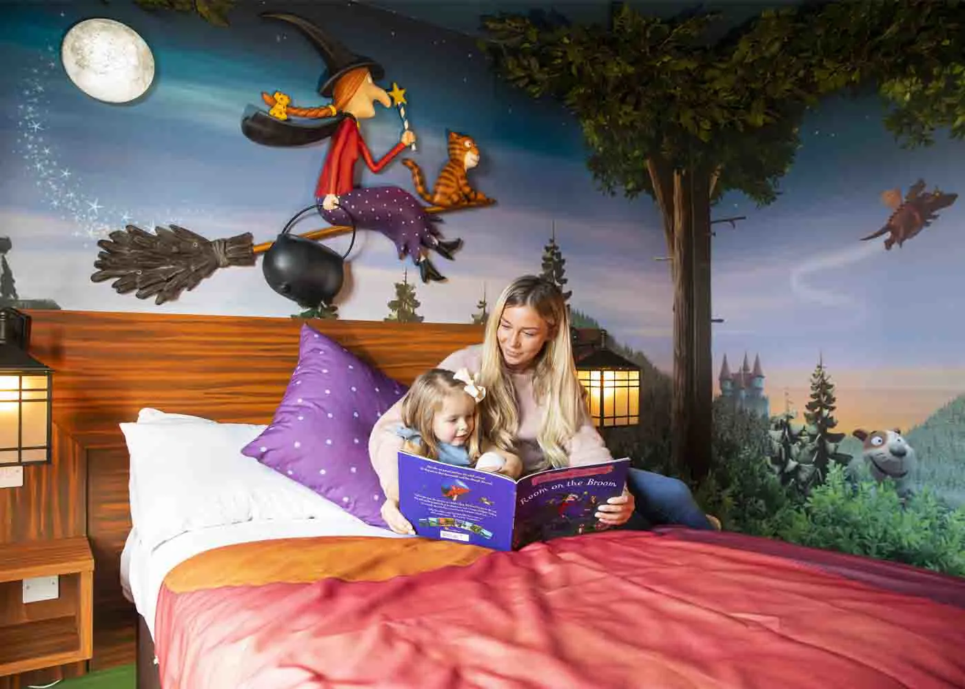 Mother and Daughter reading a book in the Room on the Broom Room at Chessington World of Adventures Resort
