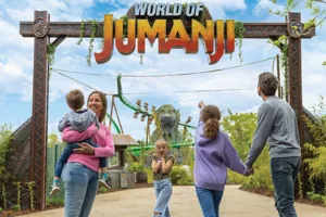 A family all walking under the World of Jumanji arch at Chessington World of Adventures
