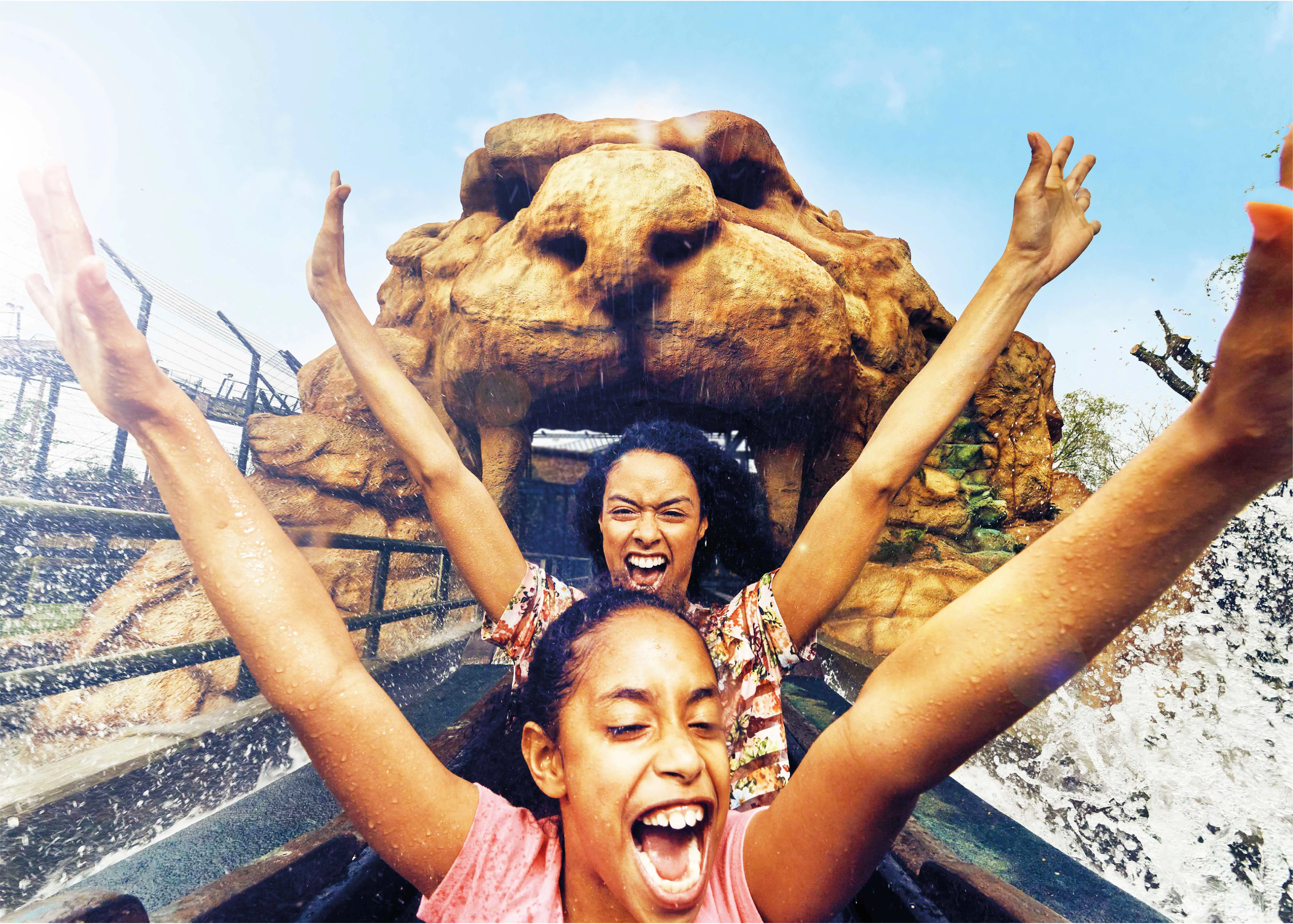 2 girls on Tiger Rock with their arms up in the air
