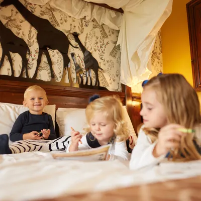 Children on bed in Chessington Family Hotel Rooms